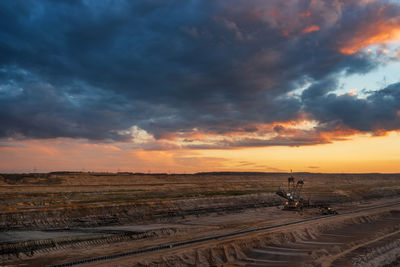 Scenic view of land against sky during sunset