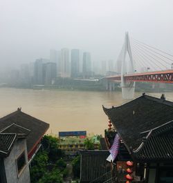 View of buildings in city during rainy season