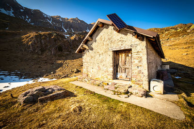 House on mountain against sky