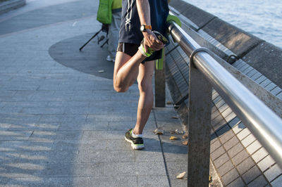 Low section of man walking on footpath