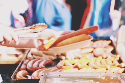 Cropped hands of man holding food for sale at market