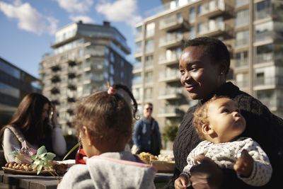 Smiling mother sitting with children