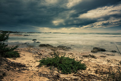 Scenic view of beach against sky during sunset