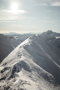 Scenic view of snowcapped mountains against sky