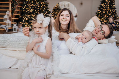 High angle view of mother and daughter lying on bed at home