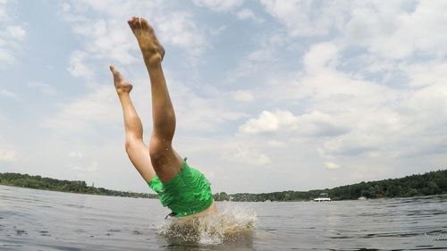 Man surfing in sea against sky