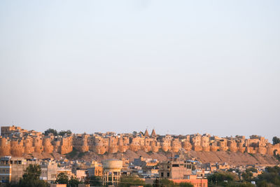 View of old fort of the golden city of jaisalmer against clear sky during blue hour
