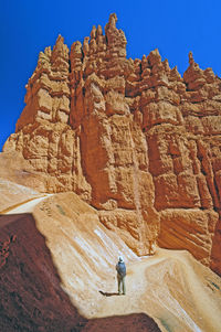 Full length of rocks on rock against sky