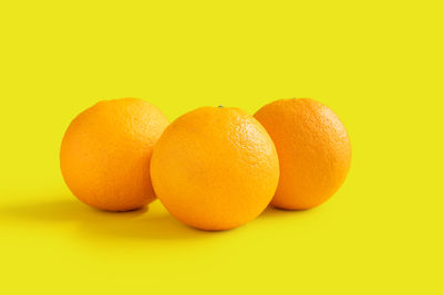 Close-up of oranges against orange background