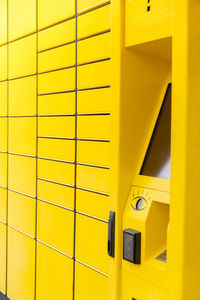 Modern yellow shopping locker. bar code reader for skans qr code on mobile phone self-service locker