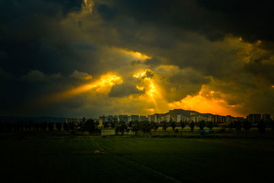 Scenic view of field against cloudy sky