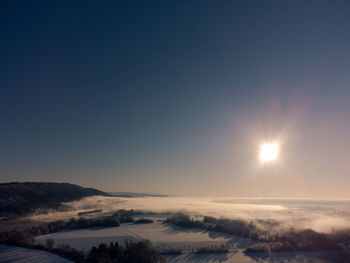 Scenic view of snowcapped landscape against sky during sunset