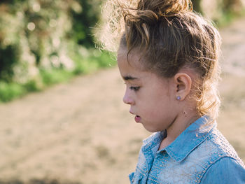 Close-up portrait of girl looking away