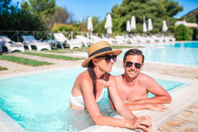 Portrait of smiling woman swimming in pool