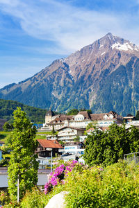 Houses by mountains against sky