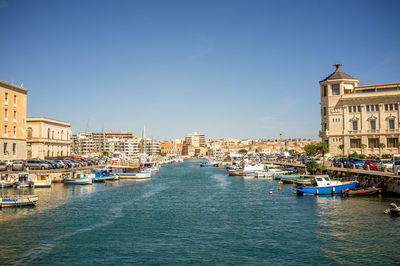 View of buildings in city against clear sky