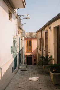 Street amidst buildings against clear sky