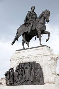 Low angle view of statue against sky