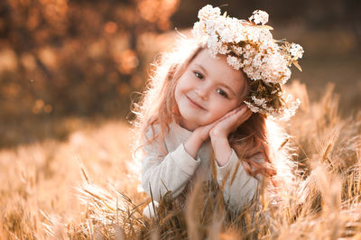 Portrait of girl wearing wreath at park