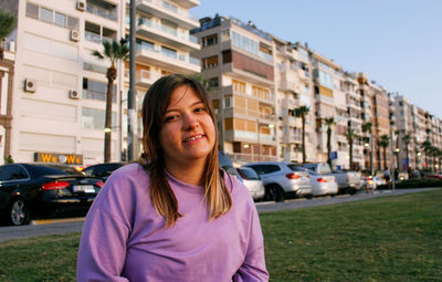 Portrait of smiling woman in city