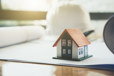 Close-up of toy on table by house