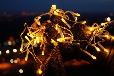 Close-up view of person holding chain of lights