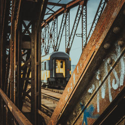 Close-up of train on railroad track against sky