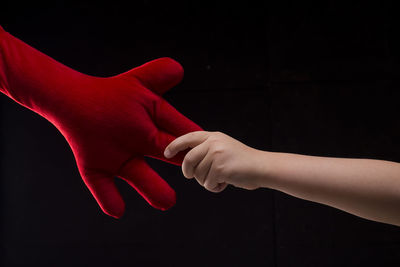 Close-up of human hand against black background