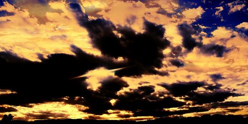 Low angle view of dramatic sky during sunset