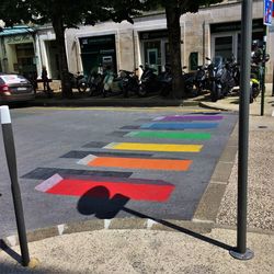 Multi colored umbrellas on road in city