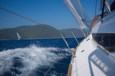 Yacht in sea against clear sky