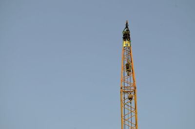 Low angle view of communications tower against clear sky