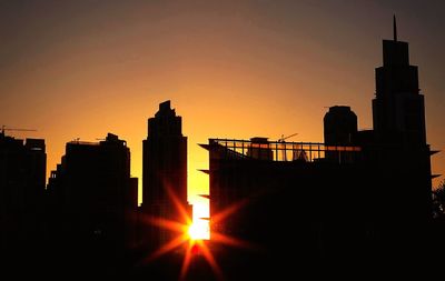 Silhouette of city at sunset