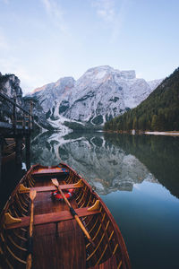 Scenic view of lake by mountains against sky