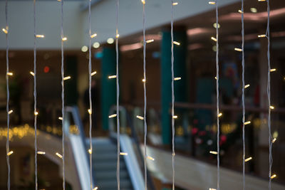 Close-up of illuminated string lights in shopping mall