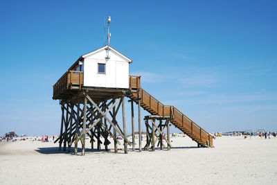 Low angle view of lifeguard hut at beach against sky