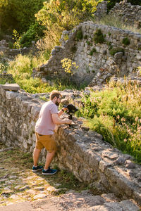 Rear view of man standing on rock