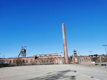 View of factory against blue sky