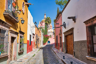 Street amidst buildings in city against sky