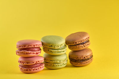 Stack of cupcakes against yellow background