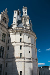 Low angle view of historical building against blue sky