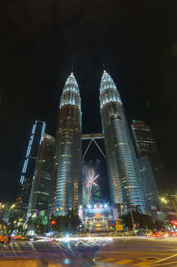 Illuminated modern buildings in city at night