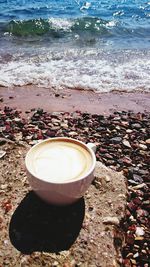 View of coffee cup on beach