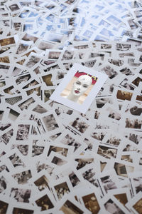Picture of female mannequin lying on top of photographic slides strewn across floor