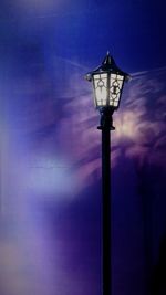 Low angle view of illuminated street light against sky at night