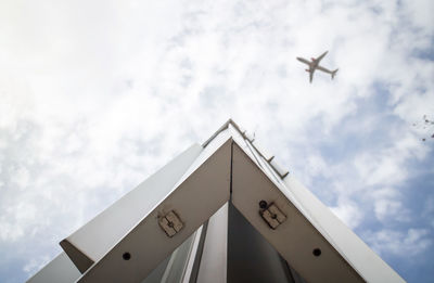 Low angle view of airplane flying against sky