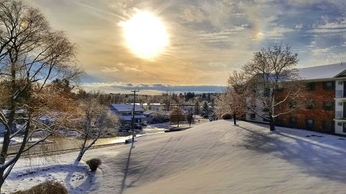 Scenic view of frozen landscape against sky during winter