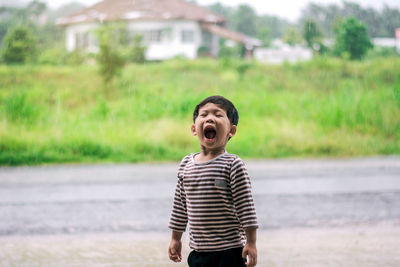 Boy standing outdoors during rainy season
