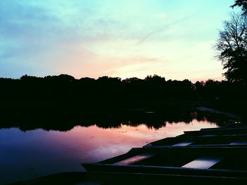 Scenic view of lake against sky at sunset