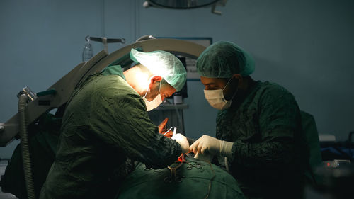 Doctors performing an appendectomy surgery, surgical concept.